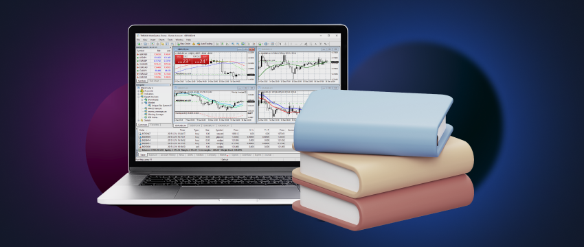 Laptop displaying forex data, accompanied by a collection of informative books