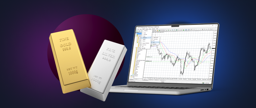 Barras de ouro e prata empilhadas ao lado de um computador portátil com um gráfico de negociação de metais que ilustra um aumento consistente dos preços dos metais.