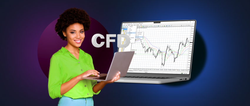 A trader holding a laptop displaying data on MT4 and a CFD behind it .